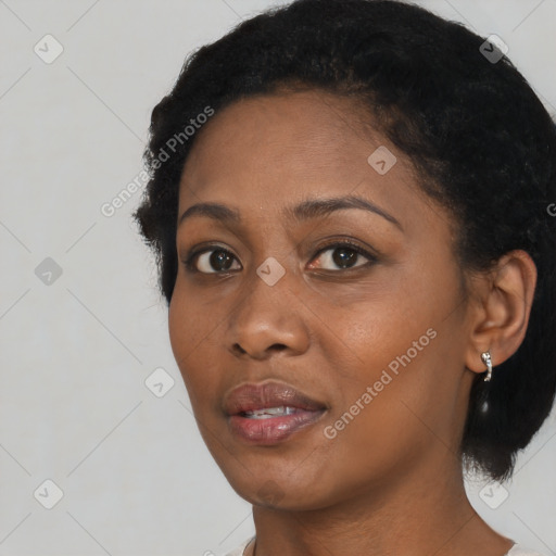 Joyful black young-adult female with short  black hair and brown eyes