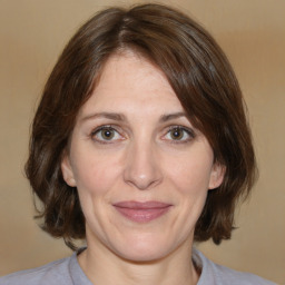 Joyful white adult female with medium  brown hair and brown eyes