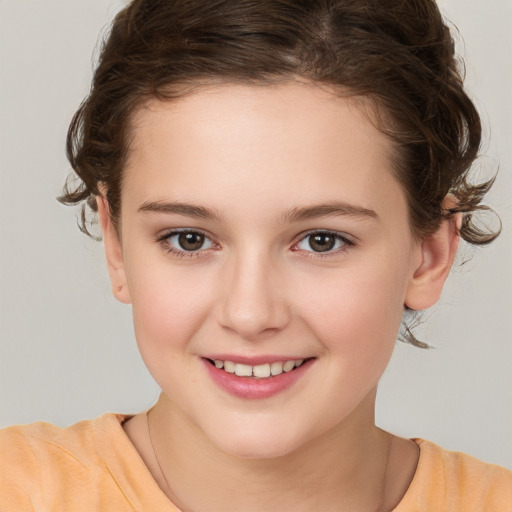 Joyful white child female with short  brown hair and brown eyes