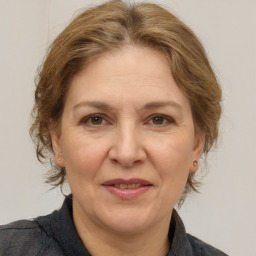 Joyful white adult female with medium  brown hair and brown eyes