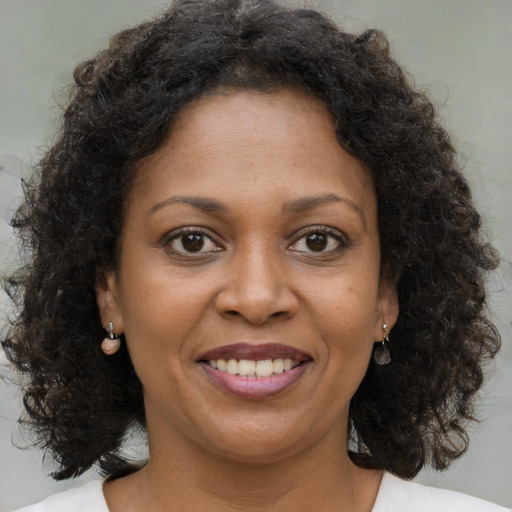 Joyful black young-adult female with medium  brown hair and brown eyes