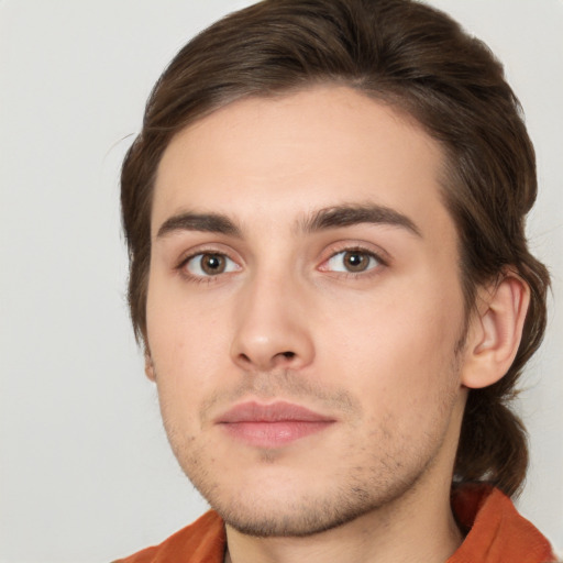 Joyful white young-adult male with medium  brown hair and brown eyes