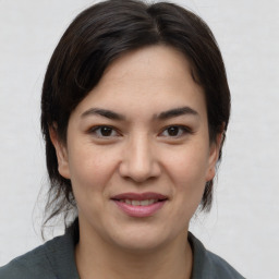 Joyful asian young-adult female with medium  brown hair and brown eyes