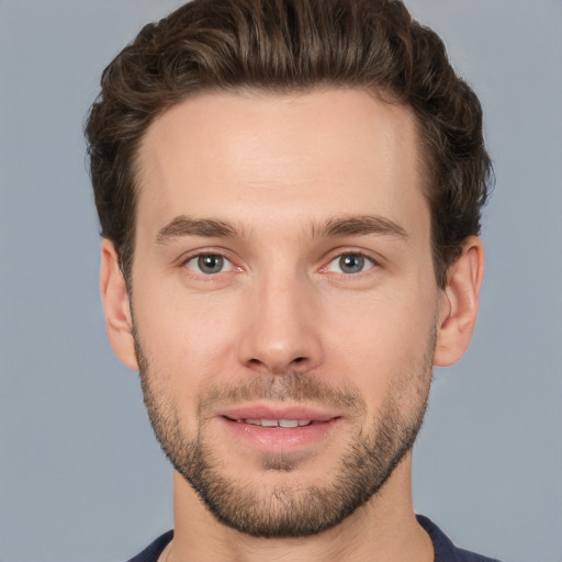 Joyful white young-adult male with short  brown hair and brown eyes