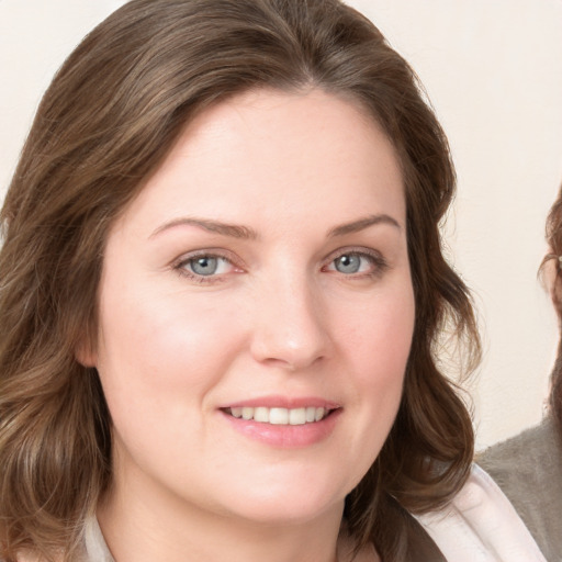 Joyful white young-adult female with medium  brown hair and blue eyes