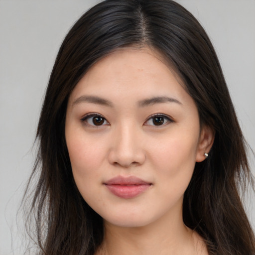 Joyful asian young-adult female with long  brown hair and brown eyes