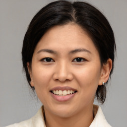 Joyful asian young-adult female with medium  brown hair and brown eyes