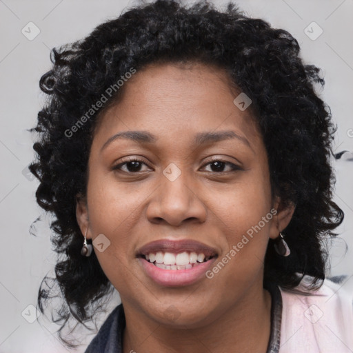 Joyful black young-adult female with long  brown hair and brown eyes