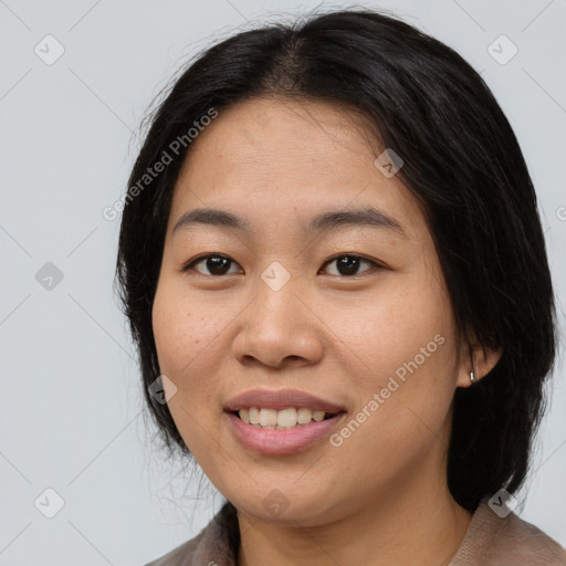 Joyful asian young-adult female with medium  black hair and brown eyes