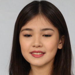 Joyful asian young-adult female with long  brown hair and brown eyes