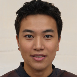 Joyful asian young-adult male with short  black hair and brown eyes