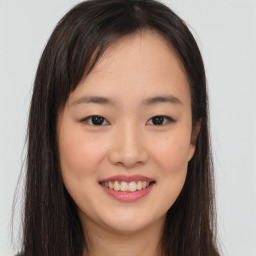 Joyful asian young-adult female with long  brown hair and brown eyes