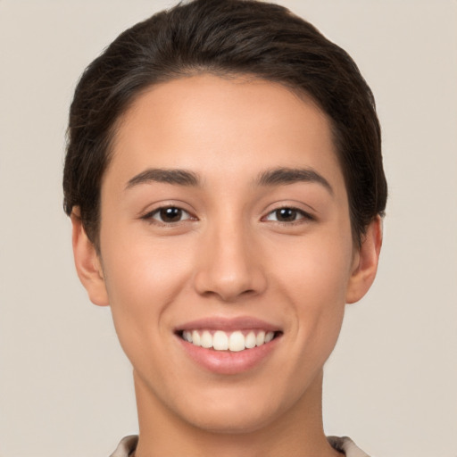 Joyful white young-adult female with short  brown hair and brown eyes