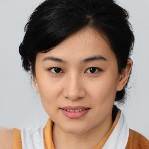 Joyful asian young-adult female with medium  brown hair and brown eyes