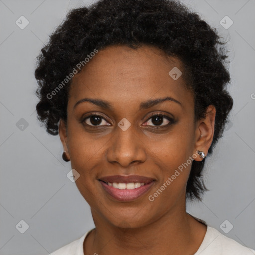 Joyful black young-adult female with short  black hair and brown eyes