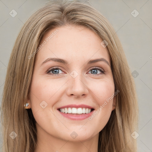 Joyful white young-adult female with long  brown hair and blue eyes