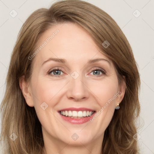 Joyful white adult female with long  brown hair and grey eyes