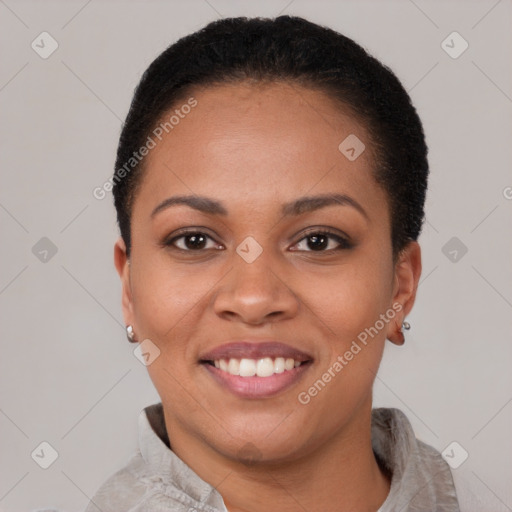 Joyful black young-adult female with short  black hair and brown eyes