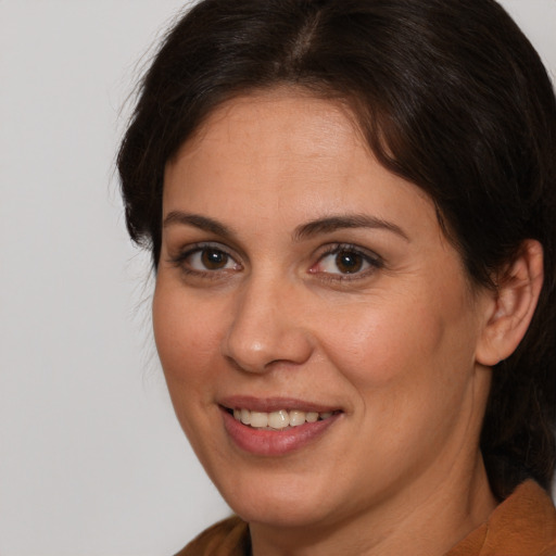 Joyful white adult female with medium  brown hair and brown eyes