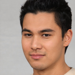 Joyful asian young-adult male with short  black hair and brown eyes