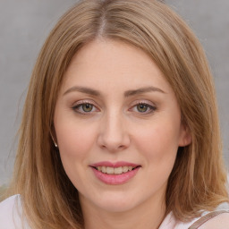 Joyful white young-adult female with medium  brown hair and blue eyes