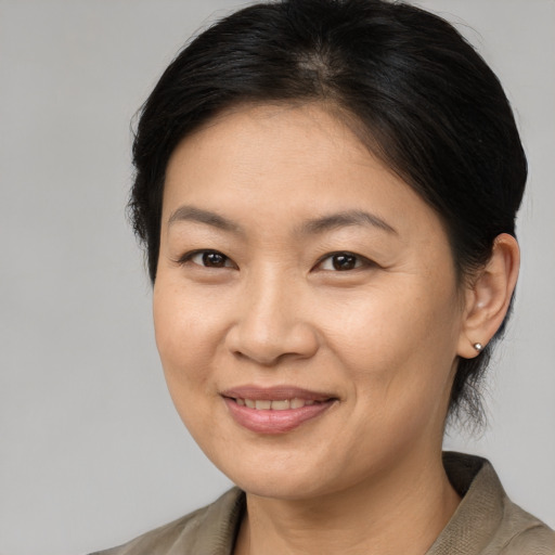 Joyful asian adult female with medium  brown hair and brown eyes