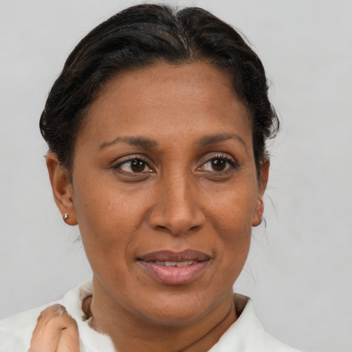 Joyful black adult female with short  brown hair and brown eyes