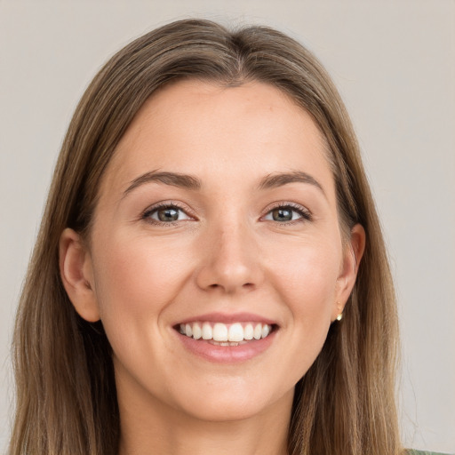 Joyful white young-adult female with long  brown hair and grey eyes