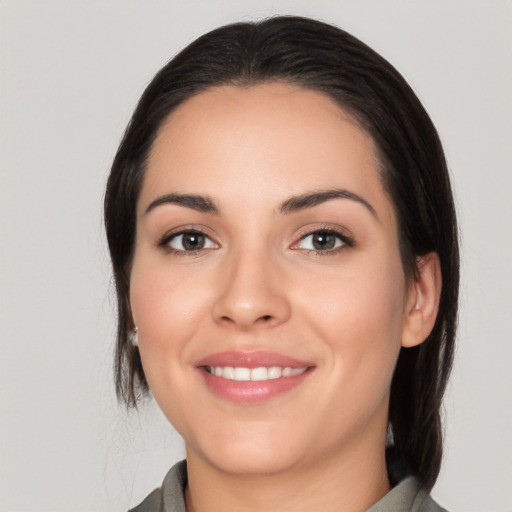 Joyful white young-adult female with medium  black hair and brown eyes