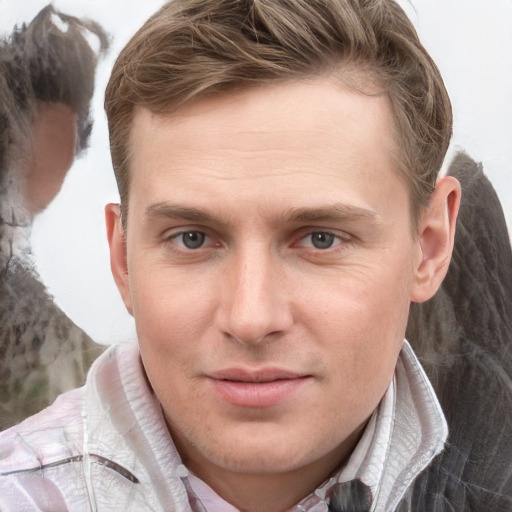 Joyful white young-adult male with short  brown hair and grey eyes