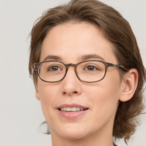 Joyful white adult female with medium  brown hair and grey eyes