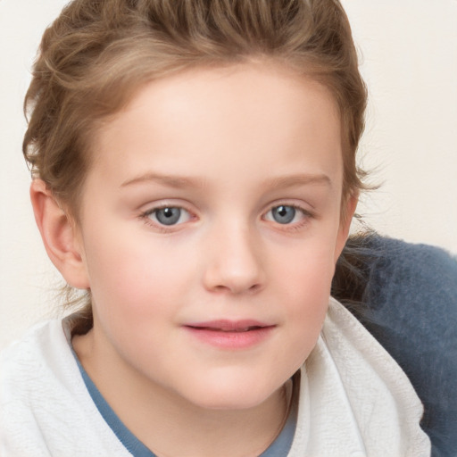 Joyful white child female with short  brown hair and blue eyes