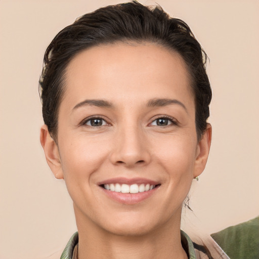 Joyful white young-adult female with short  brown hair and brown eyes