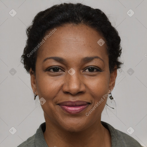 Joyful black adult female with short  brown hair and brown eyes