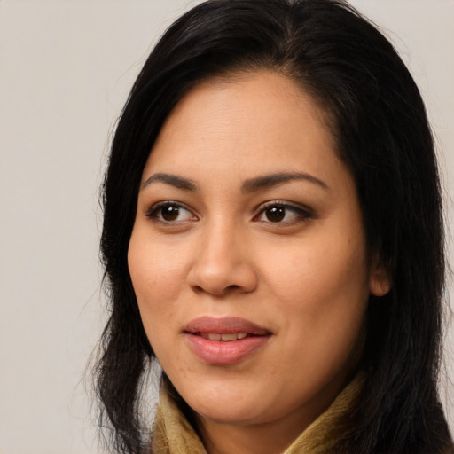 Joyful latino young-adult female with long  black hair and brown eyes