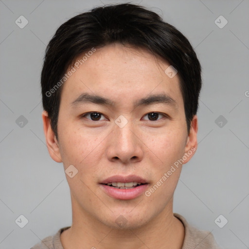 Joyful asian young-adult male with short  brown hair and brown eyes