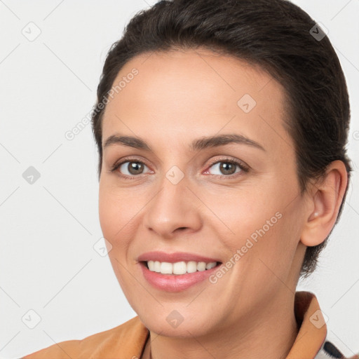 Joyful white young-adult female with short  brown hair and brown eyes