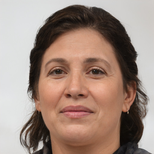 Joyful white adult female with medium  brown hair and brown eyes