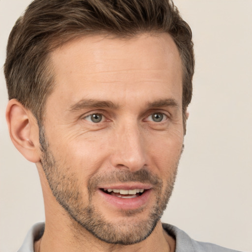 Joyful white adult male with short  brown hair and brown eyes