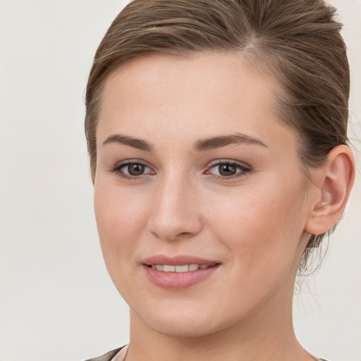 Joyful white young-adult female with long  brown hair and grey eyes