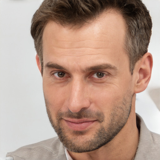 Joyful white adult male with short  brown hair and brown eyes