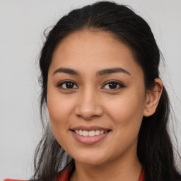 Joyful latino young-adult female with long  brown hair and brown eyes