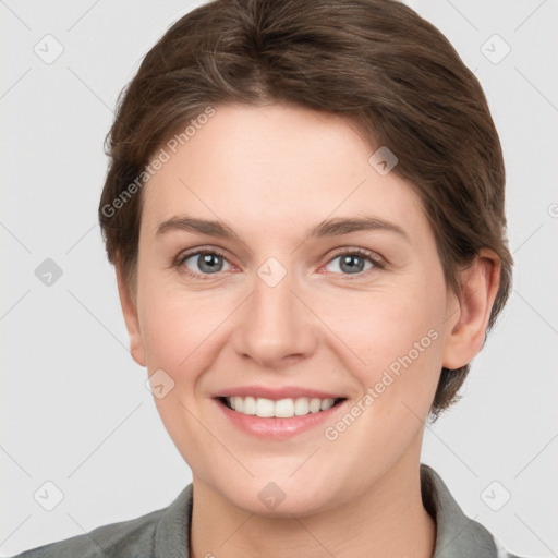 Joyful white young-adult female with short  brown hair and grey eyes