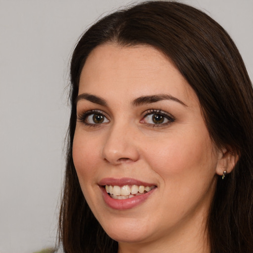 Joyful white young-adult female with long  brown hair and brown eyes