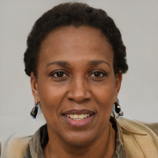 Joyful black adult female with short  brown hair and brown eyes
