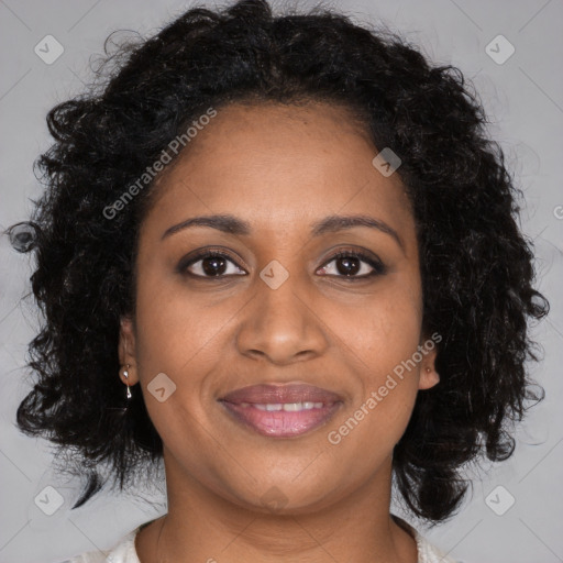 Joyful black young-adult female with long  brown hair and brown eyes
