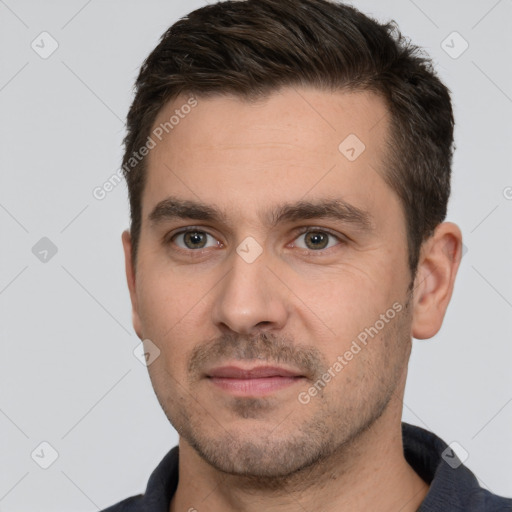 Joyful white young-adult male with short  brown hair and brown eyes