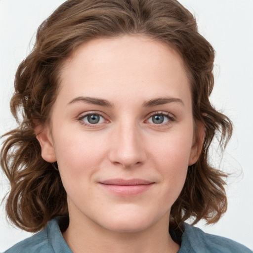 Joyful white young-adult female with medium  brown hair and blue eyes