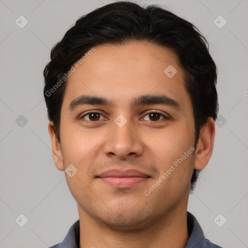 Joyful latino young-adult male with short  black hair and brown eyes