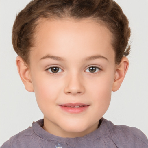 Joyful white child female with short  brown hair and brown eyes